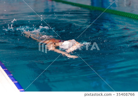 woman swimming with swimming hat in swimming pool woman swimming with swimming hat in swimming pool 35408766