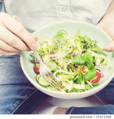 Girl holding salad 35411006