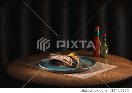 grilled pork ribs on dark plate grilled pork ribs on dark plate 35411953