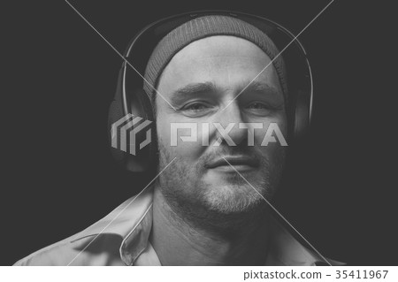 Man with headphones listens to music 35411967