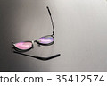 Old black glasses with broken legs. 35412574