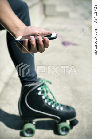 roller skater man using his smartphone 35412728