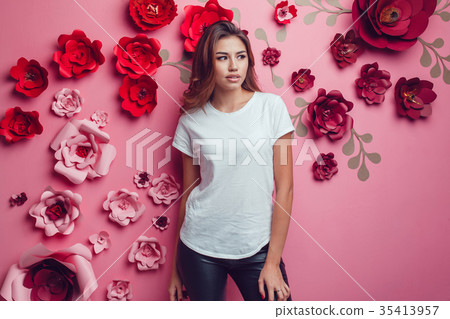 Sexy woman in a white t-shirt on a pink background 35413957