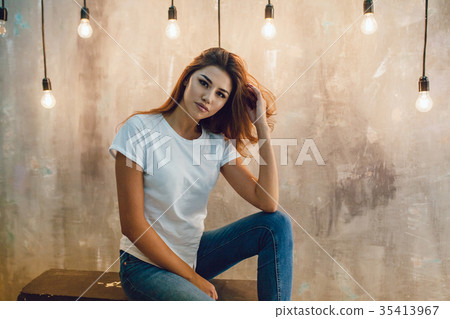 Sexy woman in a white T-shirt on a gray background 35413967