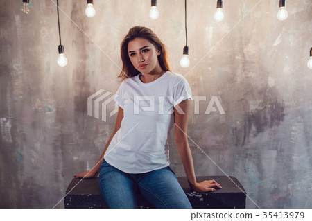 Sexy woman in a white T-shirt on a gray background 35413979