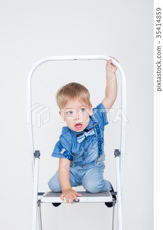 boy in a suit sitting on a stepladder boy in a suit sitting on a stepladder 35414859