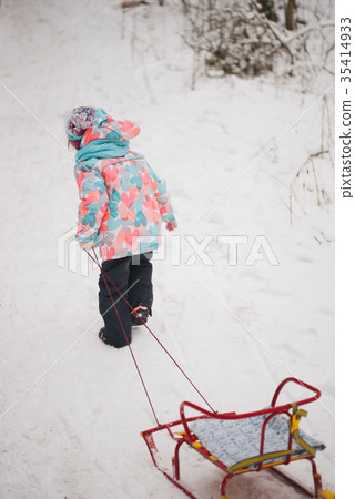cute girl with sled in snow cute girl with sled in snow 35414933