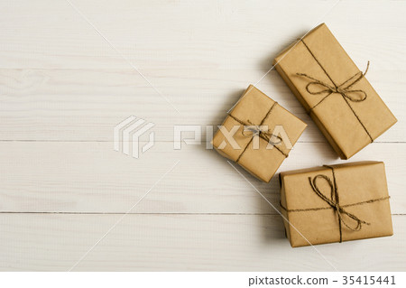 gift boxes package on white wooden background 35415441