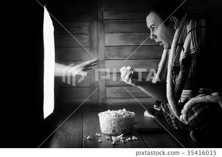 Watching a horror on TV black and white 35416015