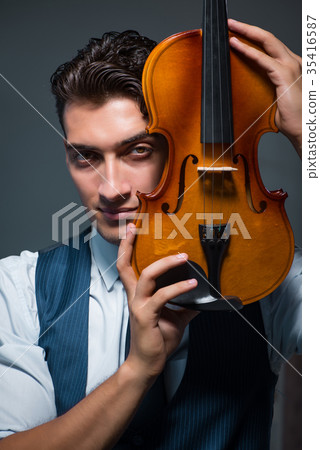 Young musician man practicing playing violin at 35416587