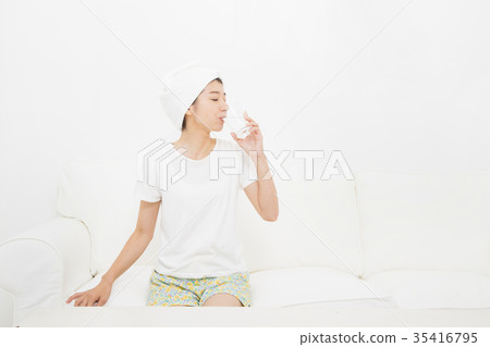 A woman drinking a glass of water A woman drinking a glass of water 35416795