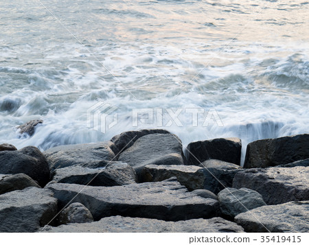 Waves hitting rocks Waves hitting rocks 35419415
