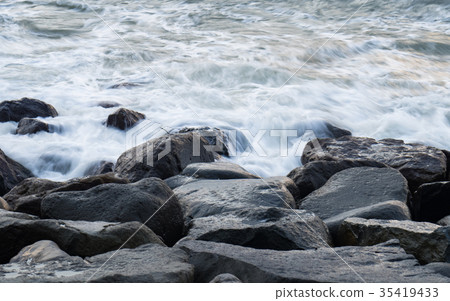 Waves hitting rocks Waves hitting rocks 35419433