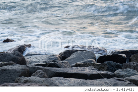 Waves hitting rocks Waves hitting rocks 35419435