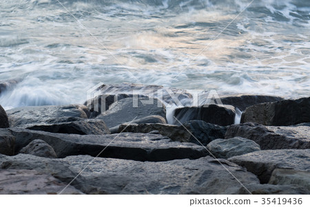 Waves hitting rocks Waves hitting rocks 35419436