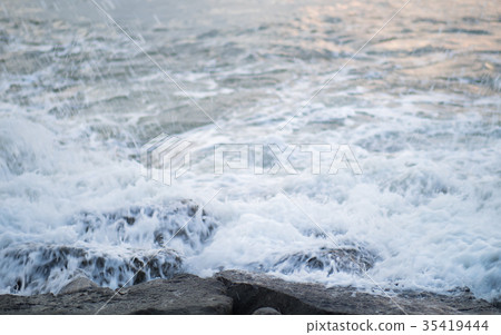 Waves hitting rocks Waves hitting rocks 35419444