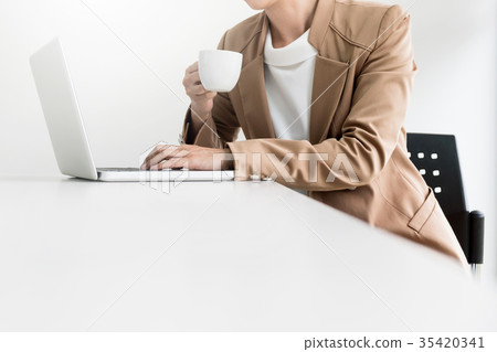 Attractive women in casual business sitting at a table working o 35420341