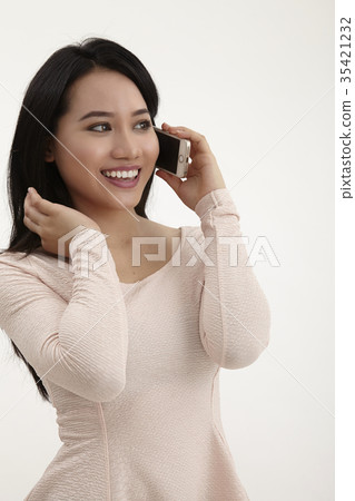 Asian woman talking on mobile phone 35421232