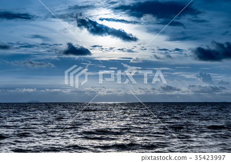 Blue dark dramatic sky with shining ocean 35423997