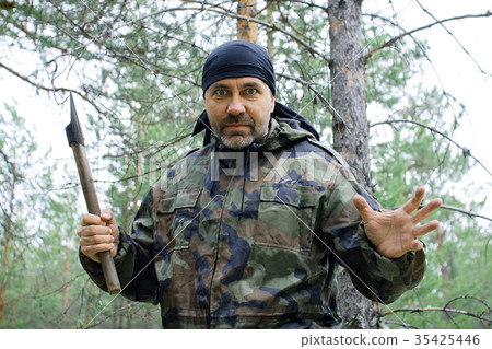 Furious man with an ax in the forest Furious man with an ax in the forest 35425446