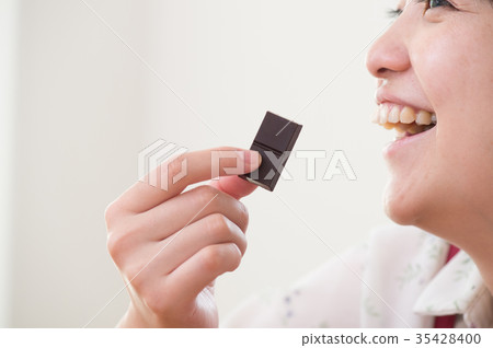 Woman eating chocolate diet image 35428400
