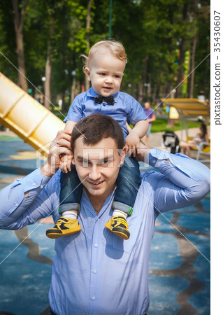 father and son walking in park father and son walking in park 35430607