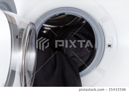 washing black clothes, open wash machine closeup 35433596