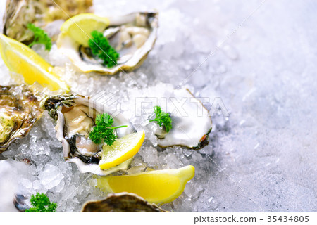Fresh opened oysters, lemon, herbs, ice on Fresh opened oysters, lemon, herbs, ice on 35434805