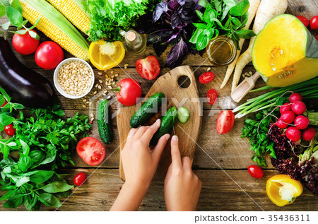Woman hands cutting vegetables on wooden Woman hands cutting vegetables on wooden 35436311
