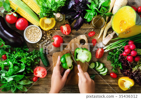 Woman hands cutting vegetables on wooden Woman hands cutting vegetables on wooden 35436312