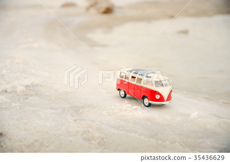 Toy car, model bus park in the sand near sea Toy car, model bus park in the sand near sea 35436629