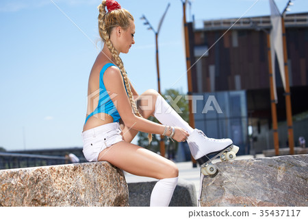 Sexy blonde riding on a retro roller Sexy blonde riding on a retro roller 35437117