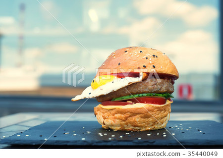 Delicious restaurant hamburger with fried egg Delicious restaurant hamburger with fried egg 35440049