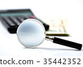 Magnifying Glass on calculator money background 35442352