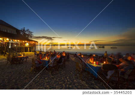 Outdoor restaurant at the beach during sunset Outdoor restaurant at the beach during sunset 35445203