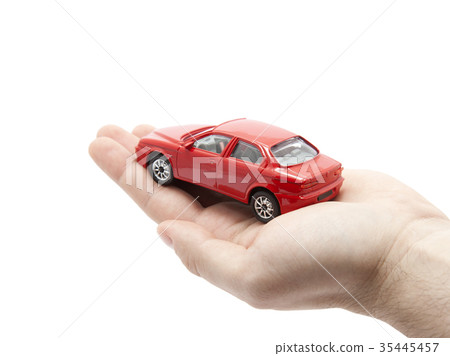 Hand holding a small red car 35445457