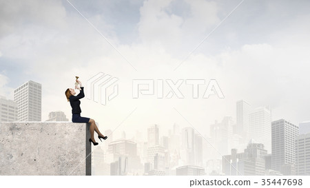 Woman speaking in horn Woman speaking in horn 35447698
