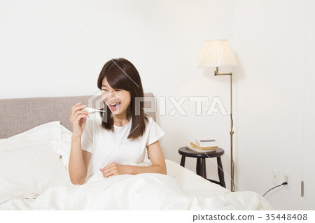 A woman with a thermometer A woman with a thermometer 35448408