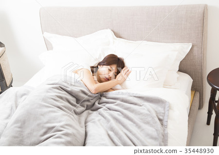 Woman sleeping in bed 35448930