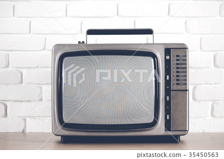 Old television on a white brick wall background. Old television on a white brick wall background. 35450563