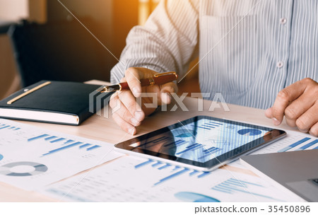 Businessman looking graph and summary report Businessman looking graph and summary report 35450896