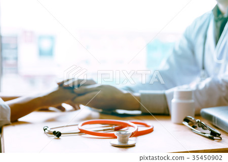 Male doctor holding hands and leaves comforting Male doctor holding hands and leaves comforting 35450902