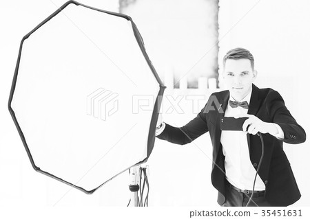 man Photographer professional in studio with flash and phone 35451631