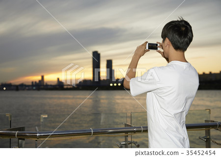 Young man, taking pictures Young man, taking pictures 35452454