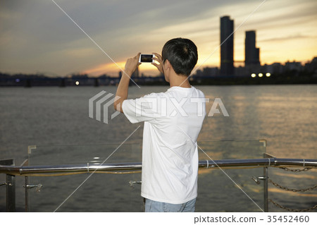 Young man, taking pictures 35452460