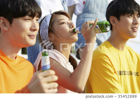 Young man, young woman, bottle of beer Young man, young woman, bottle of beer 35452899