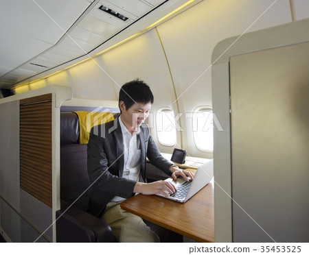 Asian man working with laptop on first class Asian man working with laptop on first class 35453525