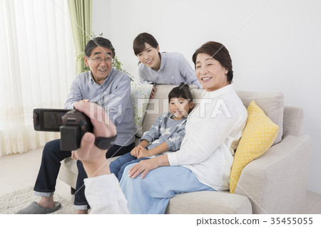 Dad shooting family with digital video camera 35455055