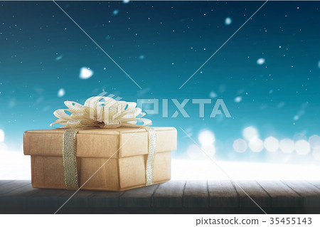 Christmas gift box with gold ribbon on table 35455143
