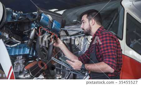 Technician inspecting engine Technician inspecting engine 35455527